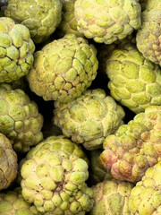 Custard apples sold at the market. It is a fruit that has many seeds.