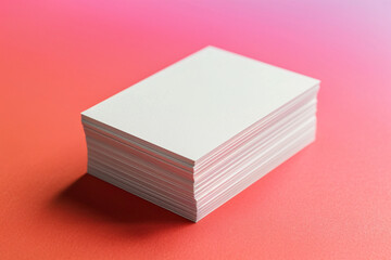A stack of blank rectangular papers on a pink and gradient background