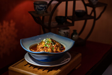 Spicy mala Chinese food in ceramic bowl with Asian style background