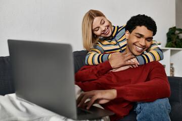 A multicultural couple shares a loving moment in their modern apartment, enjoying a relaxing evening together.