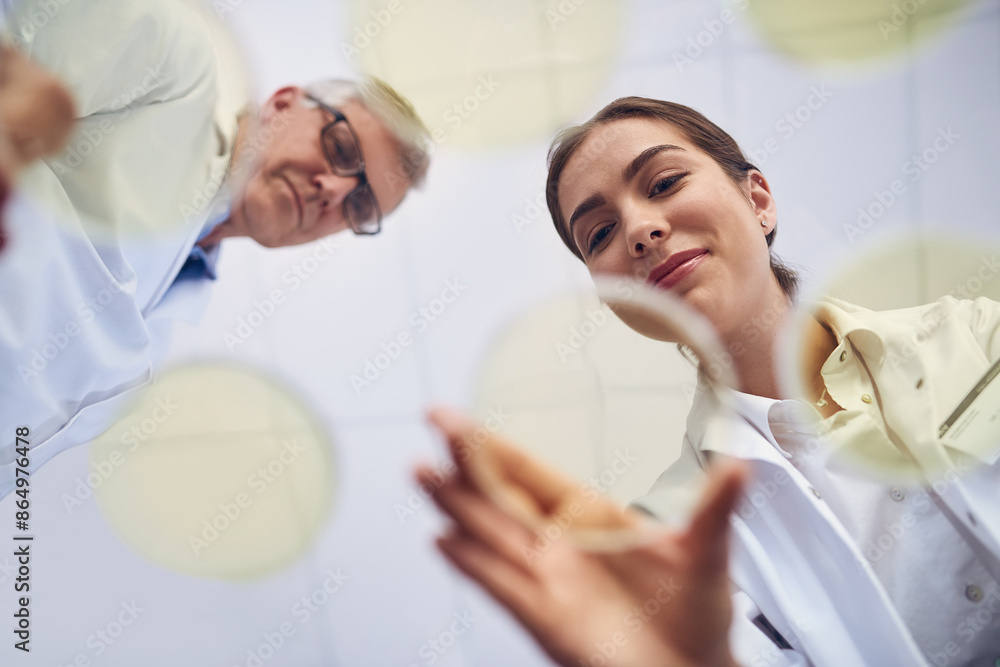 Poster breakthrough, science and teamwork with people in laboratory from below for innovation or research. 