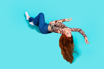 Full size photo of attractive young woman flying hang upside down dressed stylish colorful clothes...