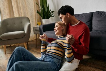 A happy multicultural couple spends time together in a modern apartment.