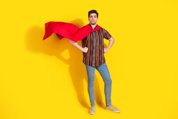 Full length portrait of nice young man wear superhero costume isolated on yellow color background