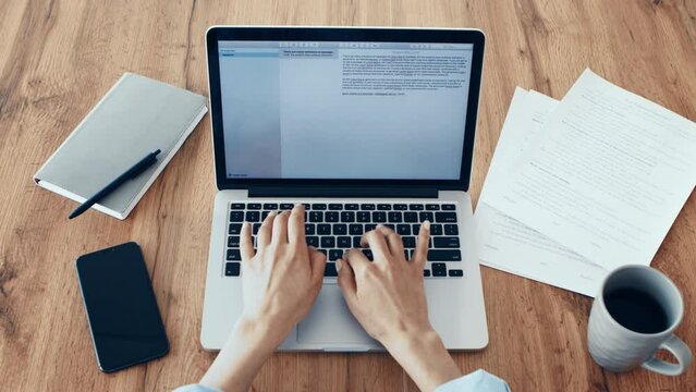 Cozy workplace. Young woman typing on laptop, enjoying coffee, pov