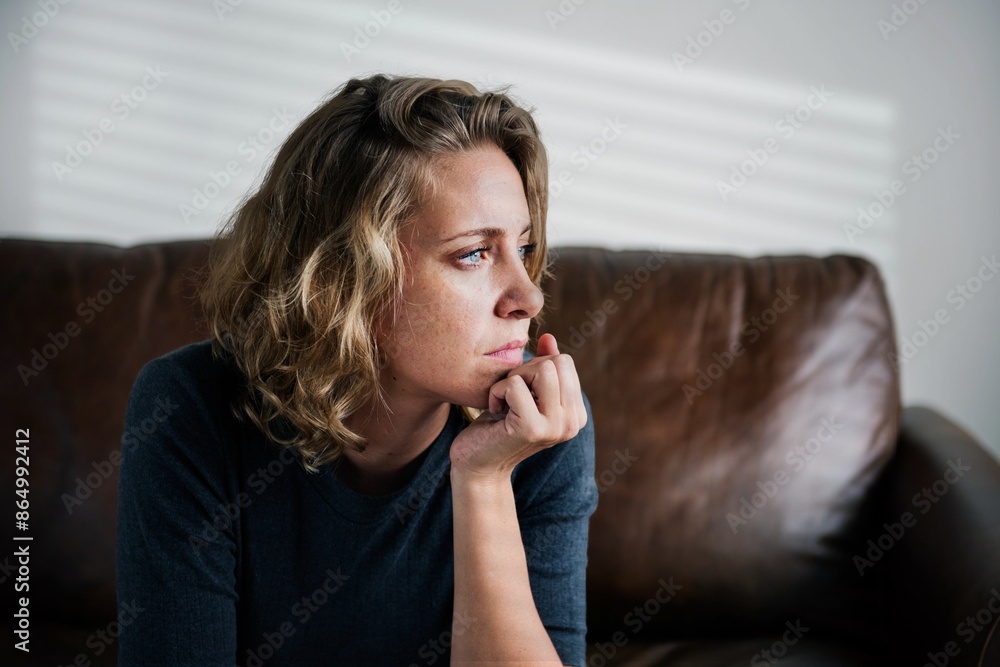 Wall mural Stress woman sitting thoughtfully alone