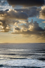 Seascape with large golden clouds at sunset. Tenerife, Spain.