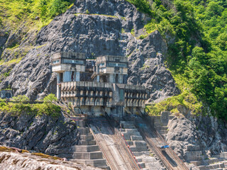 Enguri dam control building, integration of man-made structures with nature. Rugged mountain...