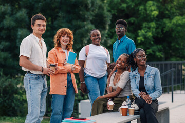 Diverse group of students posing on coffee break at college campus.