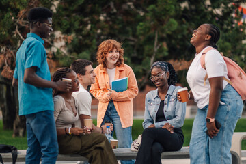 Cheerful group of diverse students having fun on coffee break at campus