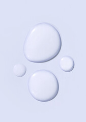 round drops of transparent gel serum on pastel background