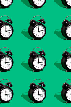 Set of retro alarm clocks against green background