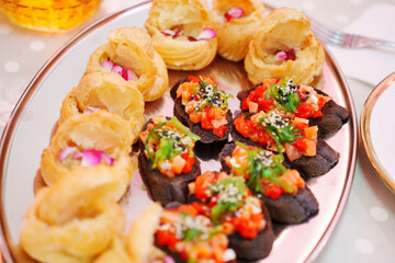 profiteroles and a baguette with vegetables on the banquet table. canapes for a buffet. catering services.
