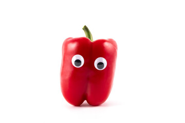 Red sweet bell pepper with eyes on a white background