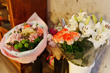 different bouquets of flowers on the floor in vases. A traditional gift for the holiday.