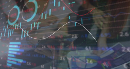 Image of financial data processing over diverse business people using tablet