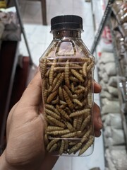 hand holding jar of dried fruit