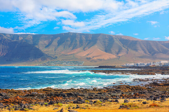 Beautiful mountain range with a blue ocean in the background. Volcanic scenery of Famara from Lanzarote, Canary Islands
