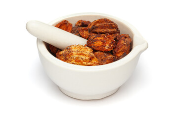 Close-up of Dry Organic Stone Apple or Bel (Aegle marmelos) fruit, in white ceramic mortar and pestle, isolated on a white background.