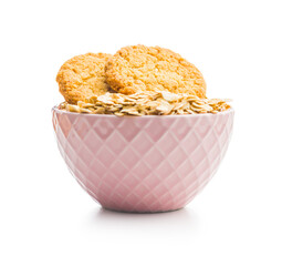 Tasty oatmeal cookies and rolled oat  isolated on white background.