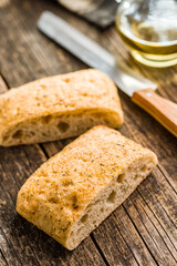 Italian ciabatta bread on wooden table.