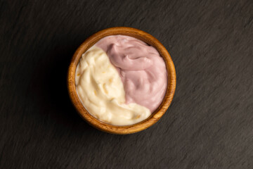 vanilla and raspberry flavored yogurt in a wooden bowl