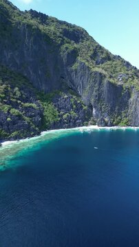 Aerial footage of Talisay Beach on a sunny day in Tapiutan Island, El Nido, Palawan, Philippines
