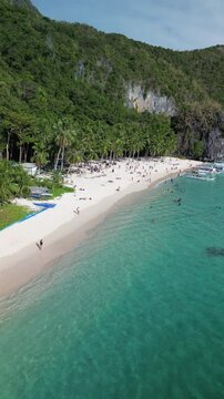 Aerial footage of the beachgoers at Seven Commandos Beach in El Nido, Palawan island, Philippine