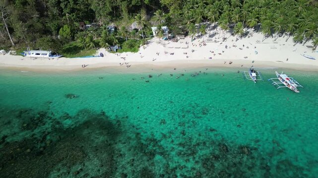 Drone footage of the beachgoers at Seven Commandos Beach in El Nido, Palawan, Philippine