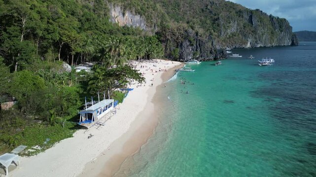 Aerial footage of tourists at Seven Commandos Beach on a sunny day in El Nido, Philippine