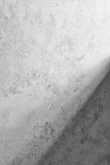 A textured wall with natural shadows illuminated by natural light.