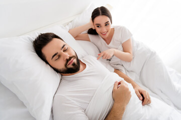 Photo of two people guy sleeping girl touch his shoulder feeling in bedroom house