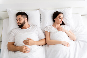 Photo of two people couple sleeping in bed in white modern house indoors