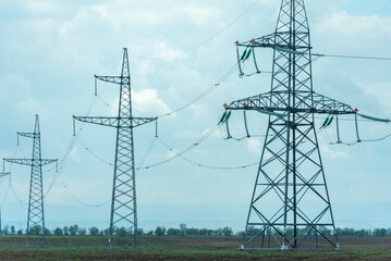 High voltage towers with sky background. Power line support with wires for electricity...