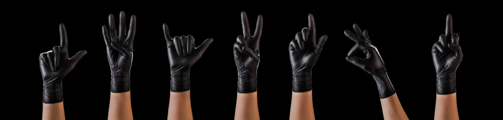 Hands in black gloves showing different gestures, pointing and showing signs