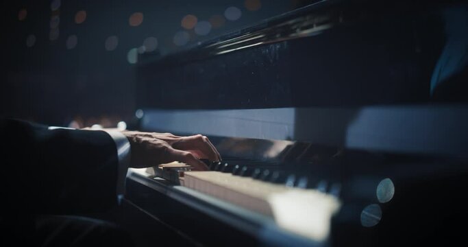 Classical Piano Concert: Under the Spotlight, Close Up on Pianist Hands Delivering a Powerful Performance on the Grand Piano. His Passionate Playing Leaving the Audience Happy. Slow Motion Footage