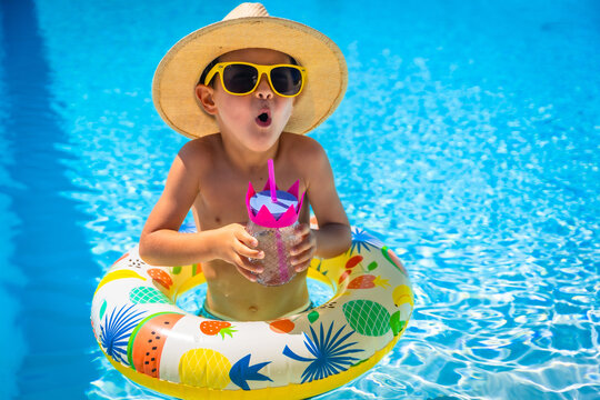 Happy boy drinking water inside a pool - Powered by Adobe