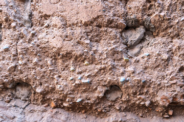 Textured old walls, traditional Moroccan rough stone houses, adobe construction. Mix of natural materials