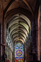 Fototapeta premium Interior of Collegiale Saint Aubin in Guerande, France with Stained Glass