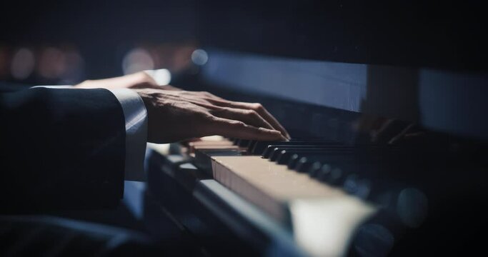 Close Up on Pianist Hands Playing a Mesmerizing Jazz Melody on a Black Grand Piano. Anonymous Artist is Focused on Creating Beautiful Instrumental Sonata as He Plays on Stage for the Audience