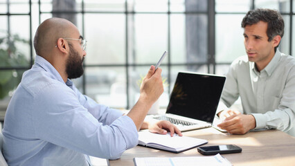 Fototapeta premium Businessman working on the table with laptop in a new office