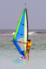 Woman windsurfing on Unawatuna Beach, Sri Lanka