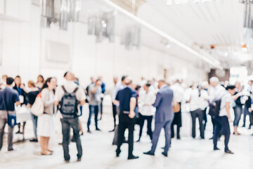 Abstract blurred people socializing during coffee break at business meeting or conference.
