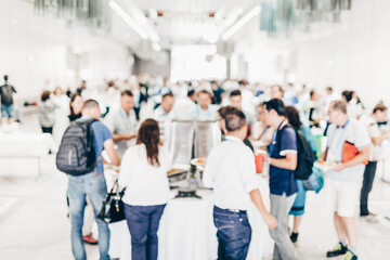 Abstract blurred people socializing during buffet lunch break at business meeting or conference.