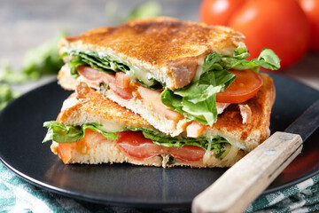Healthy spinach, tomato and cheese sandwich on wooden table. Close up