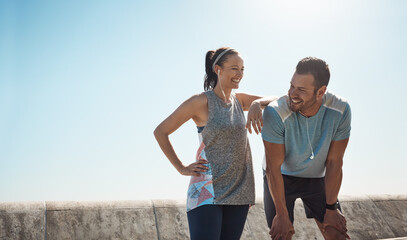 Happy, fitness and tired couple for running listening to music, audio and radio for cardio workout. Sports, wellness and man and woman outdoors for exercise, marathon training and relax on promenade