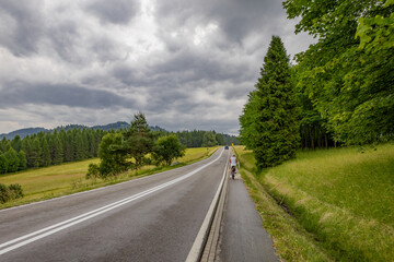 Fototapeta premium Bicycle route for a trip around Lake Czorsztyn, panorama of the Tatra Mountains