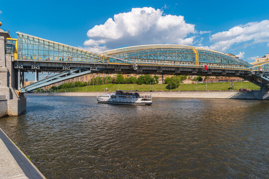 Moscow, Russia - May 20, 2024: View of the Bogdan Khmelnitsky Bridge with a passing motor ship on the Moskva River.