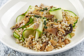 burley with fresh vegetables on white plate