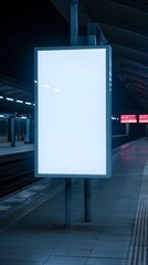 Empty illuminated billboard on a metro station platform at night, ideal for advertising and commercial placements in urban settings.
